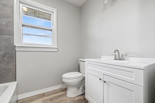 200 N Madison Ave, Mansfield, MO 65704 - bathroom with a bathing tub, baseboards, toilet, wood finished floors, and vanity