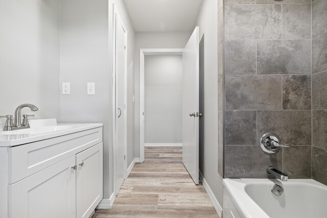 200 N Madison Ave, Mansfield, MO 65704 - bathroom featuring vanity, shower / washtub combination, baseboards, and wood finished floors