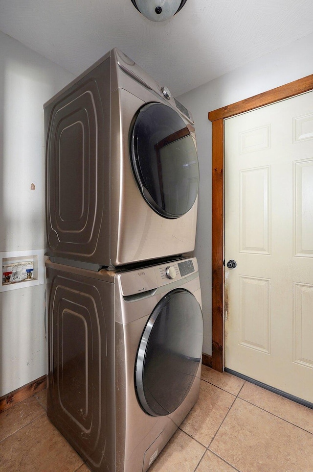 1471 Woodland Rd, Marshfield, MO 65706 - laundry room featuring estacked washer and dryer and light tile patterned floors