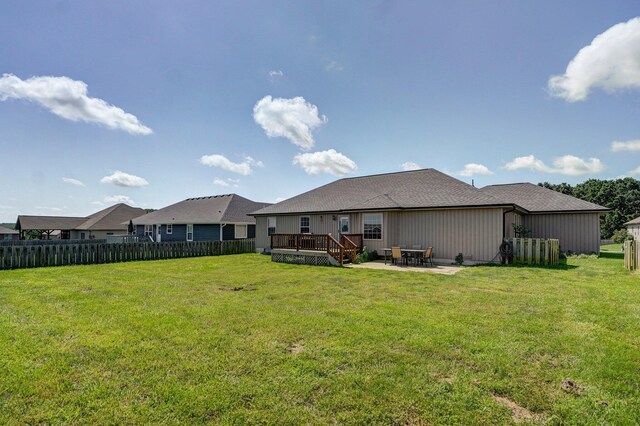 1471 Woodland Rd, Marshfield, MO 65706 - back of property featuring a deck, a patio area, and a shingled roof