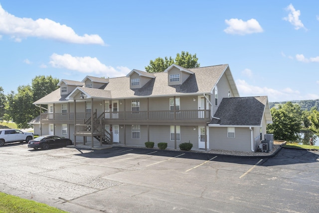 4 Memory Ln Unit 3, Branson, MO 65616 - view of front facade with uncovered parking, roof with shingles, stairway, and a porch
