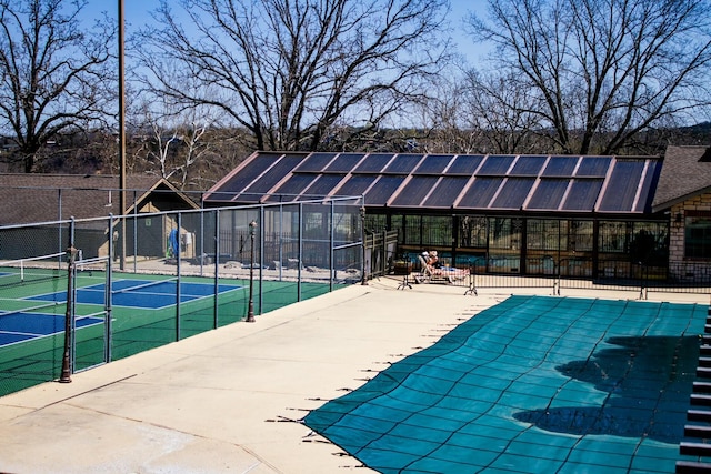 view of pool with a tennis court and fence