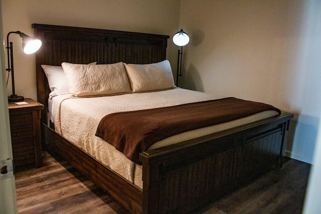 bedroom with dark wood-style floors