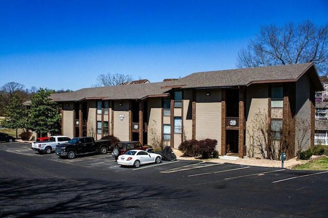 view of building exterior featuring uncovered parking