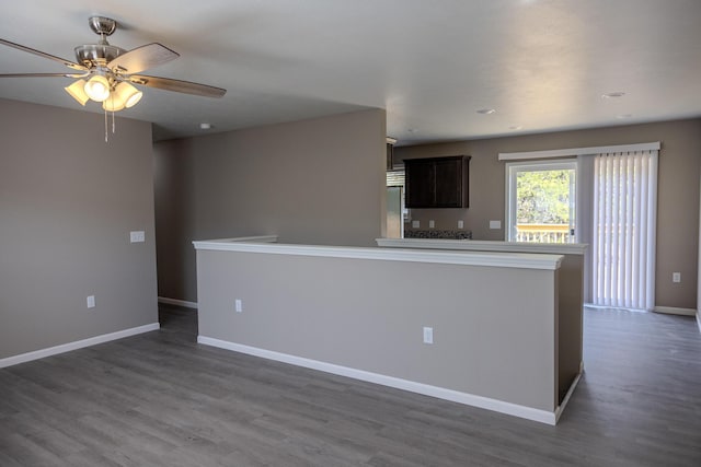 kitchen with a ceiling fan, dark wood-style flooring, dark brown cabinetry, and baseboards