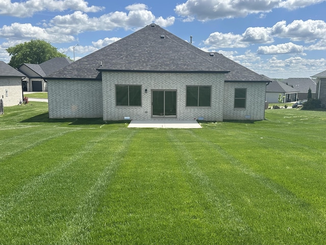 1293 W Gaslight Dr, Springfield, MO 65810 - rear view of house with a lawn, a shingled roof, a patio area, and brick siding