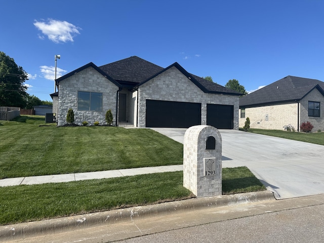 1293 W Gaslight Dr, Springfield, MO 65810 - view of front of property featuring a garage, a front yard, stone siding, and concrete driveway