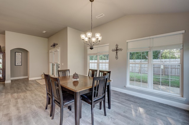 1859 Boyer Pl, Webb City, MO 64870 - dining room featuring vaulted ceiling, light wood-type flooring, arched walkways, visible vents, and a notable chandelier