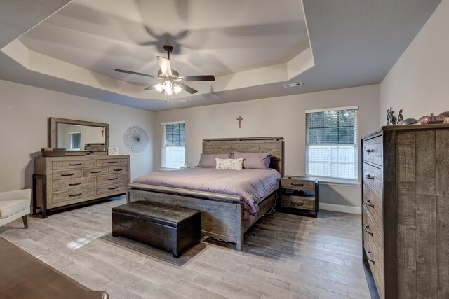 1859 Boyer Pl, Webb City, MO 64870 - bedroom with a tray ceiling, wood tiled floor, visible vents, and a ceiling fan