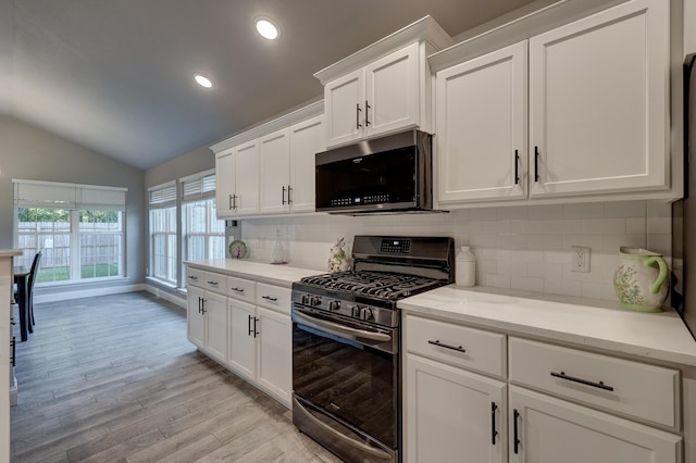 1859 Boyer Pl, Webb City, MO 64870 - kitchen featuring white cabinets, stainless steel appliances, light wood-style floors, and decorative backsplash