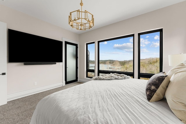 bedroom featuring baseboards, carpet floors, and a chandelier
