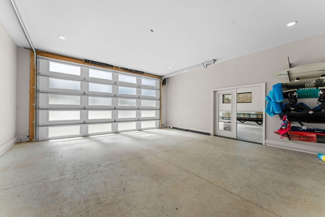 garage featuring baseboards and recessed lighting