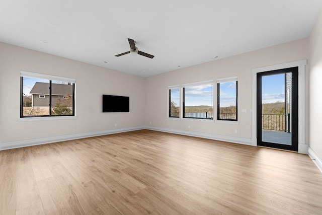 interior space featuring baseboards, light wood-style flooring, and ceiling fan