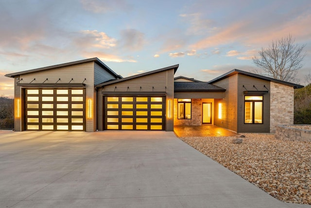 contemporary home featuring concrete driveway and a garage