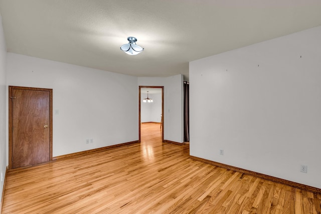 2505 Courtney Pl, West Plains, MO 65775 - unfurnished room with light wood-style floors, baseboards, and a chandelier