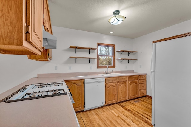 2505 Courtney Pl, West Plains, MO 65775 - kitchen with white appliances, open shelves, a sink, light wood-style floors, and light countertops