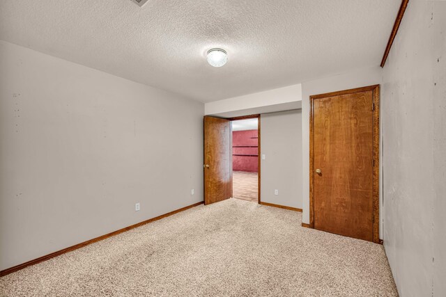 2505 Courtney Pl, West Plains, MO 65775 - carpeted spare room featuring a textured ceiling and baseboards