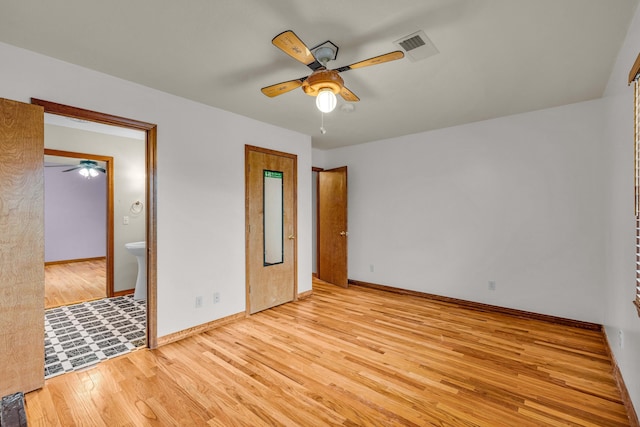 2505 Courtney Pl, West Plains, MO 65775 - unfurnished bedroom featuring wood finished floors, baseboards, connected bathroom, and ceiling fan