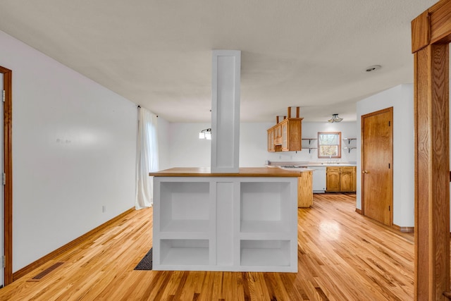2505 Courtney Pl, West Plains, MO 65775 - kitchen with open shelves, light wood finished floors, brown cabinetry, and dishwasher