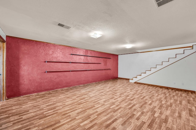 2505 Courtney Pl, West Plains, MO 65775 - finished basement featuring wood finished floors, stairway, and a textured ceiling