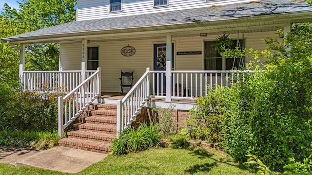 2505 Courtney Pl, West Plains, MO 65775 - view of exterior entry featuring covered porch and roof with shingles