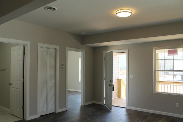 423 W Division St, Springfield, MO 65803 - spare room with visible vents, dark wood-style flooring, and baseboards
