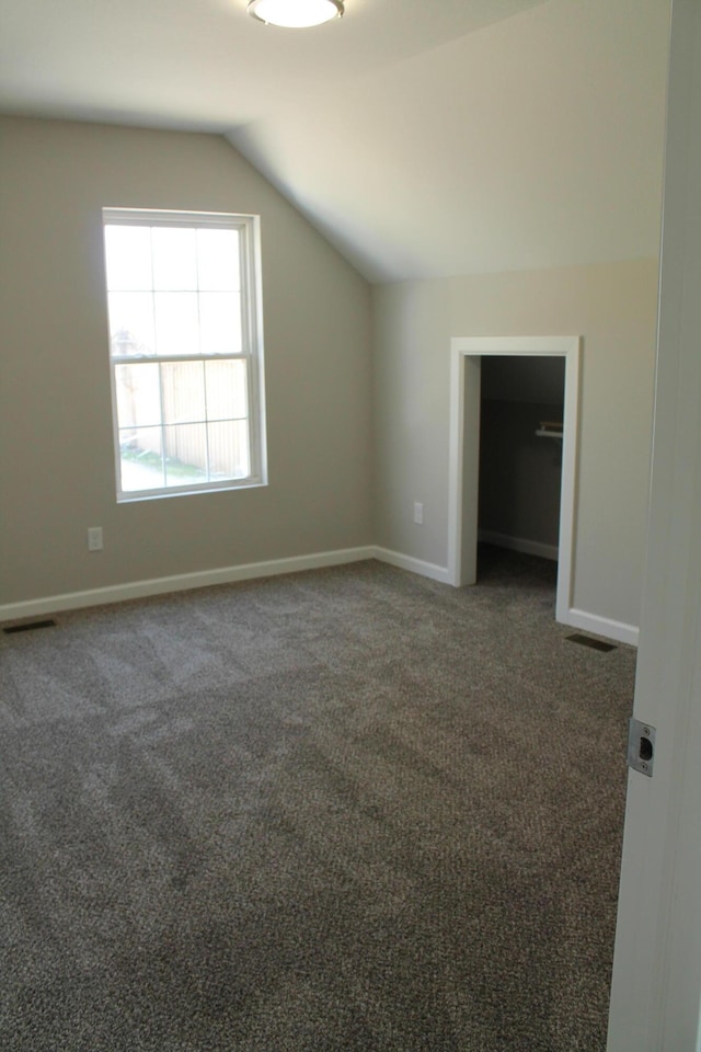 423 W Division St, Springfield, MO 65803 - additional living space featuring visible vents, baseboards, carpet, and vaulted ceiling