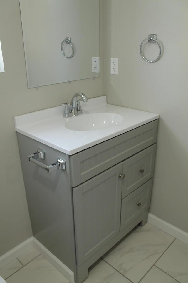 423 W Division St, Springfield, MO 65803 - bathroom featuring marble finish floor, baseboards, and vanity