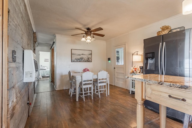 dining room featuring a ceiling fan, ornamental molding, and dark wood finished floors