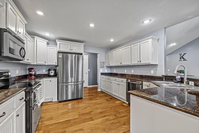 445 E Sequoia St, Republic, MO 65738 - kitchen with appliances with stainless steel finishes, a sink, light wood-style flooring, white cabinets, and recessed lighting