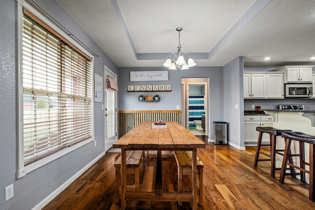 445 E Sequoia St, Republic, MO 65738 - dining room with a chandelier, dark wood-style floors, baseboards, a tray ceiling, and a textured ceiling