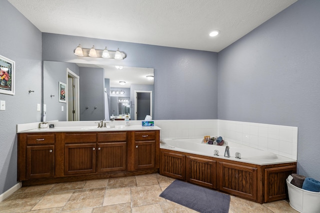445 E Sequoia St, Republic, MO 65738 - bathroom with vanity, a garden tub, and a textured ceiling