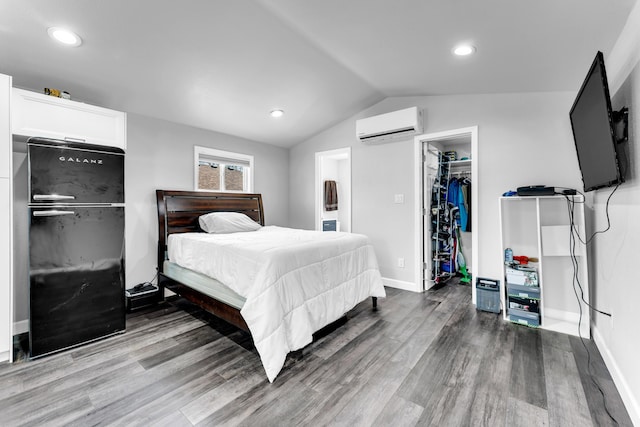 504 Brown St, Branson, MO 65616 - bedroom with an AC wall unit, wood finished floors, lofted ceiling, a walk in closet, and a closet