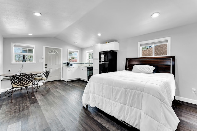 504 Brown St, Branson, MO 65616 - bedroom with freestanding refrigerator, vaulted ceiling, dark wood-style floors, a sink, and baseboards