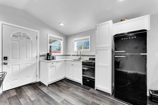 504 Brown St, Branson, MO 65616 - kitchen with black appliances, lofted ceiling, white cabinets, a sink, and dark wood-style floors