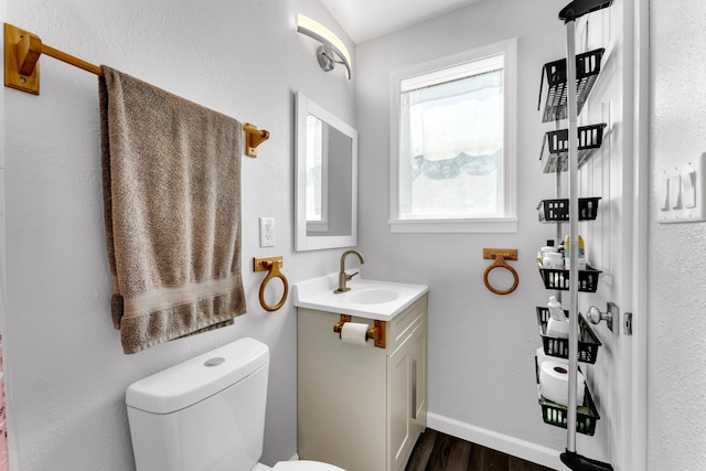 504 Brown St, Branson, MO 65616 - bathroom with wood finished floors, toilet, vanity, and baseboards