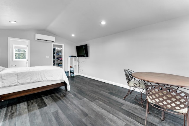 504 Brown St, Branson, MO 65616 - bedroom featuring a wall mounted air conditioner, vaulted ceiling, dark wood-style floors, a walk in closet, and baseboards