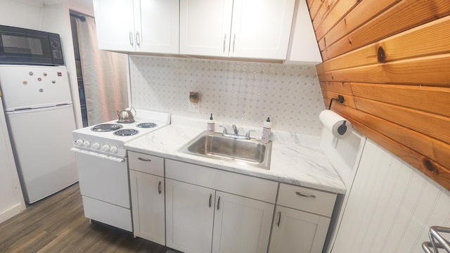 kitchen featuring white appliances, dark wood-type flooring, a sink, white cabinets, and light stone countertops