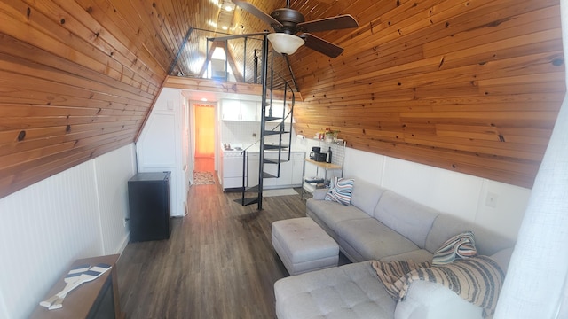 interior space with wood walls, dark wood-type flooring, lofted ceiling, separate washer and dryer, and wood ceiling