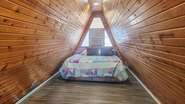 unfurnished bedroom with wood walls, lofted ceiling, and wood finished floors