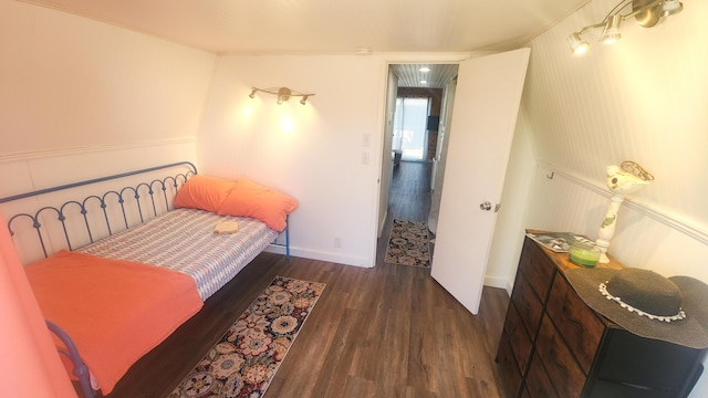 bedroom featuring baseboards and wood finished floors