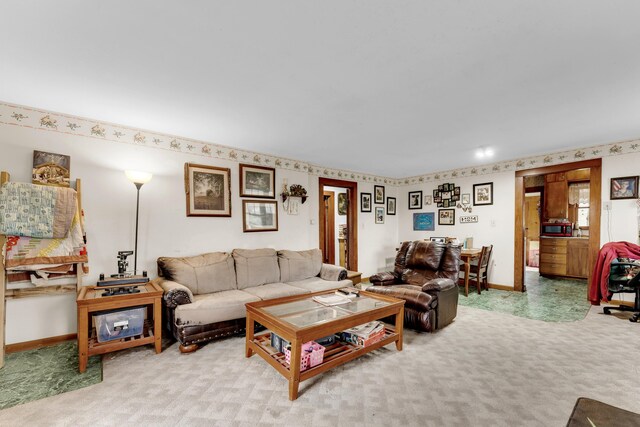 carpeted living area with baseboards