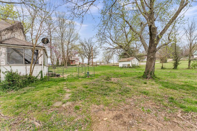 view of yard with an outdoor structure and a storage shed