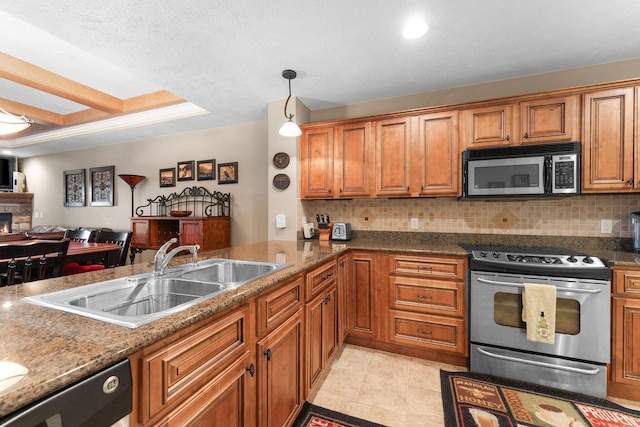 kitchen featuring a sink, brown cabinetry, tasteful backsplash, and appliances with stainless steel finishes