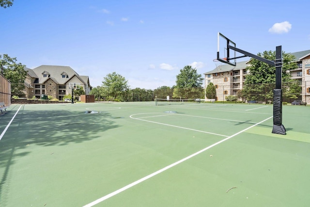 view of sport court featuring a tennis court, community basketball court, and fence