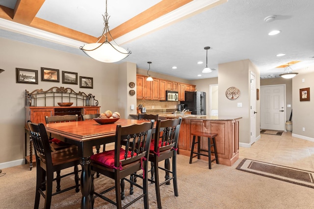 dining room featuring a raised ceiling, baseboards, light colored carpet, and recessed lighting