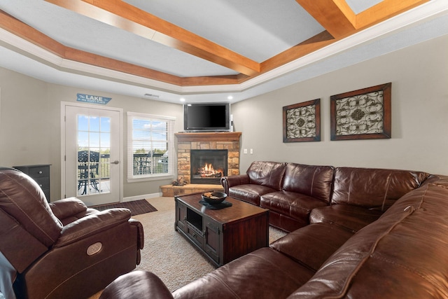 carpeted living room featuring a tray ceiling, a fireplace, beamed ceiling, baseboards, and visible vents