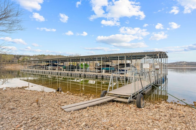 dock area with a water view and boat lift