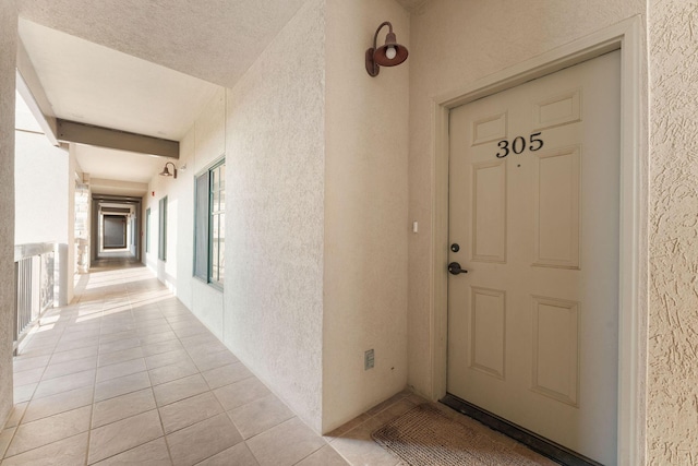 view of exterior entry with stucco siding