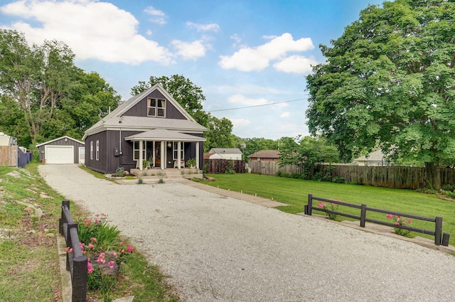 404 N Mcqueary Ave, Ash Grove, MO 65604 - view of front of house featuring covered porch, an outdoor structure, driveway, and a garage